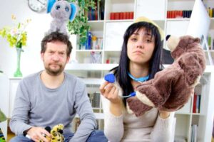 genitori disperati che raccolgono i giochi dei figli sul pavimento